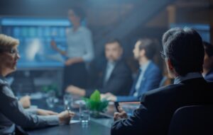 Investors around a table listening to presentation