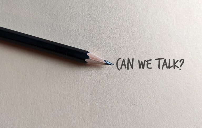 Pencil with writing "can we talk?"