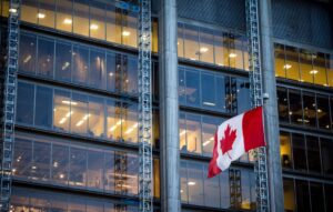 Canadian flag in front of business skyscraper