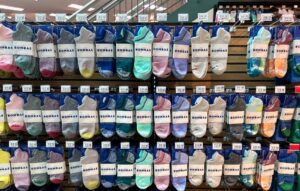 The image is a display of Bombas socks for sale at the Scheels Sporting Goods store in Springfield, Illinois.