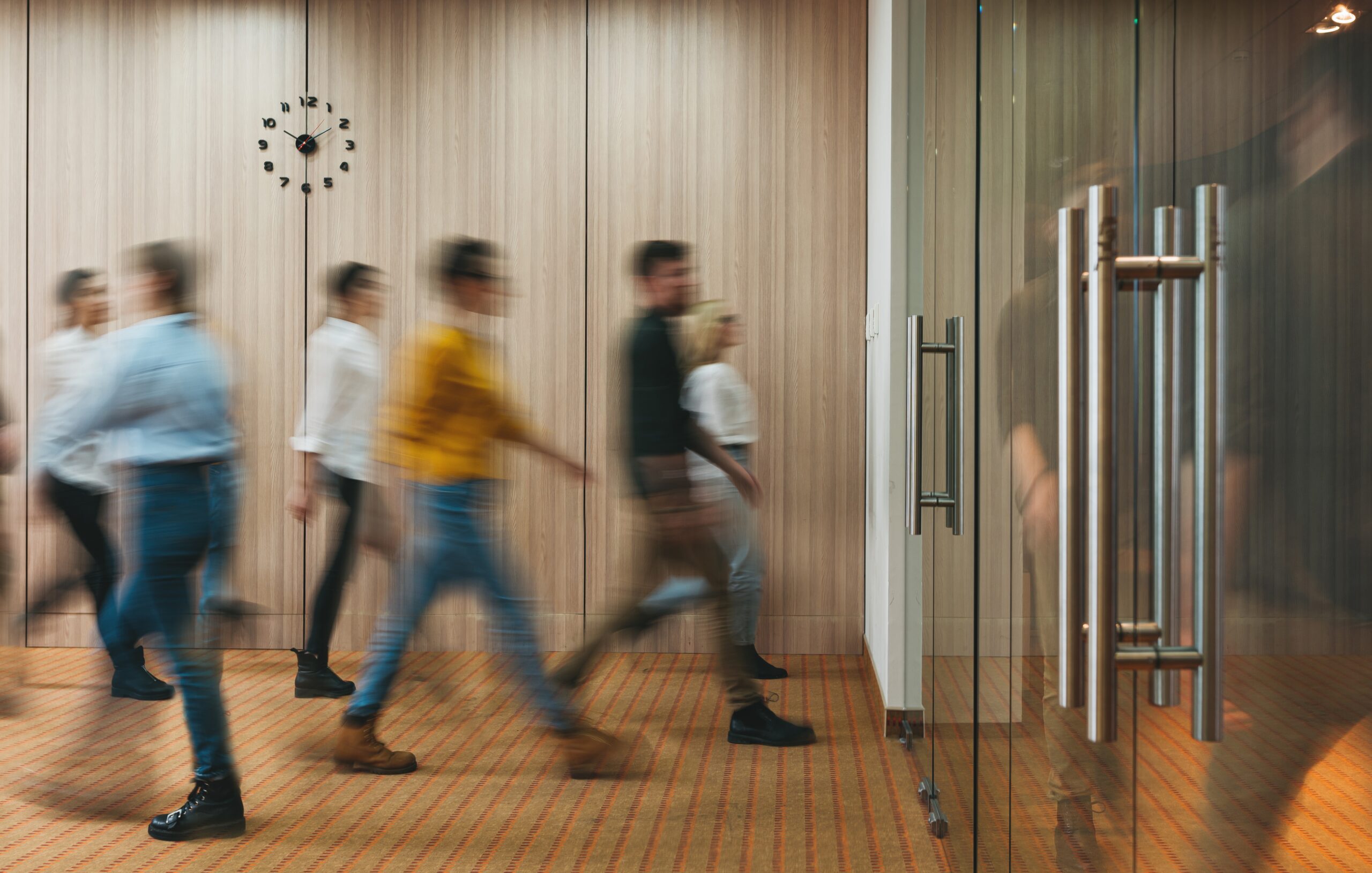 Group of office people walking at office open space. Team of business employees at coworking center. People at motion blur.