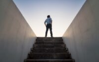 CEO at the top of the stairs looking out toward the future.