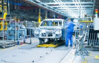 Car production line, workers are working.