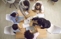 Team collaborating at a table together.