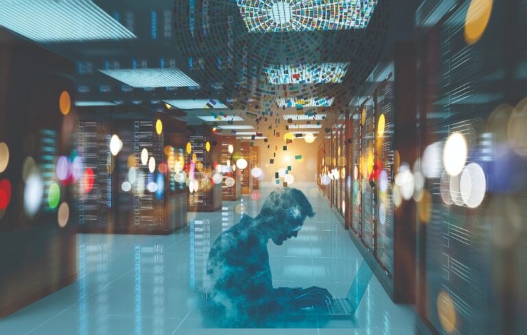 Composite image of man sitting on laptop in data server room
