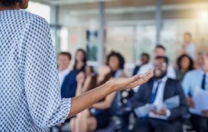 Female leader speaking to employees.