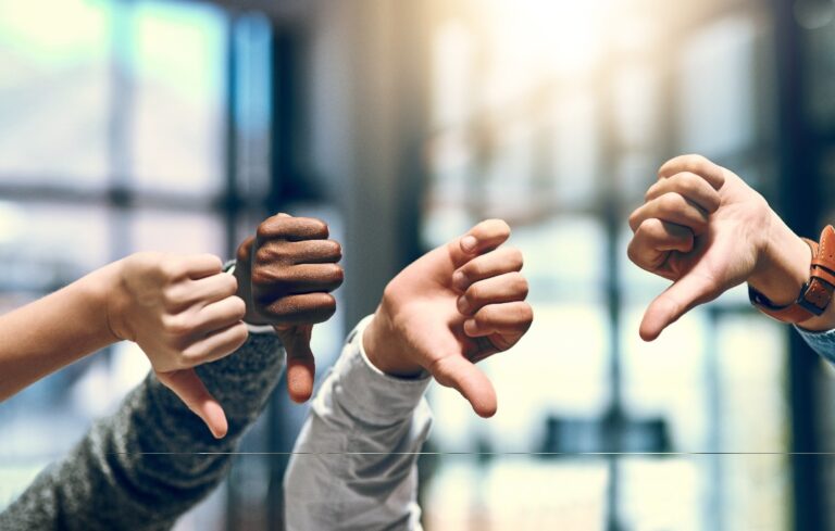 Group of hands, thumbs down