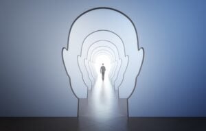walking man back leading to light spot in the end of corridor through walls in form of human heads