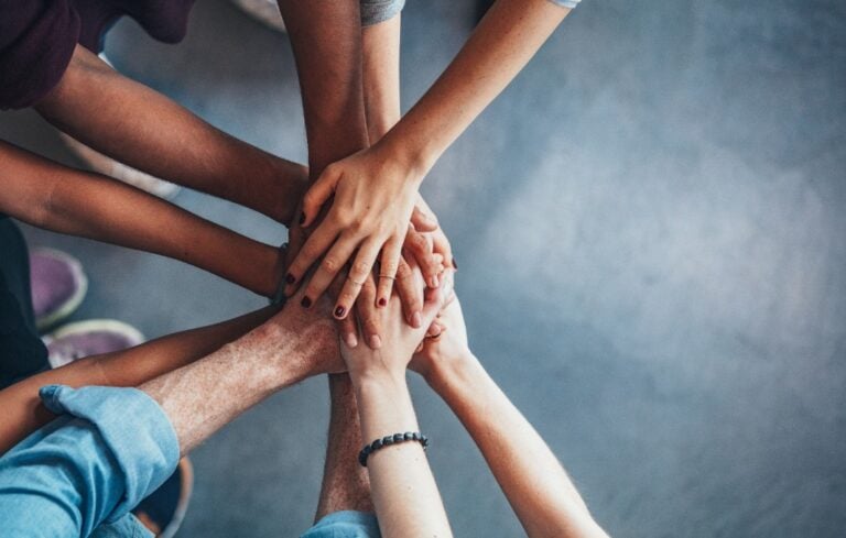 Stack of hands showing unity and teamwork