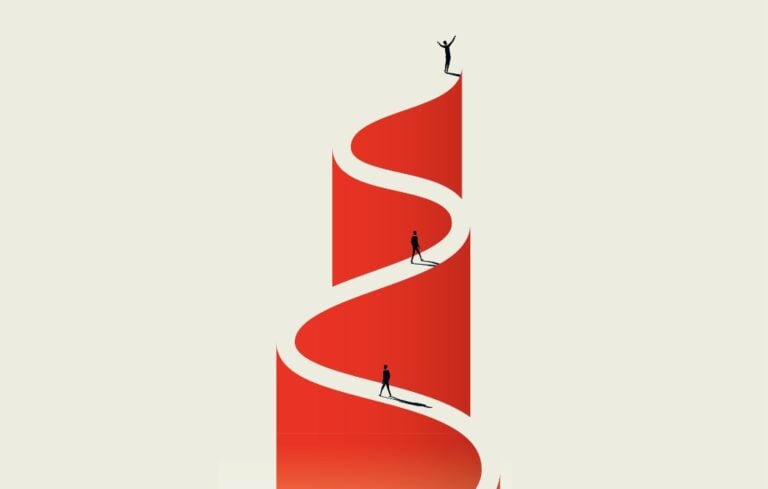 Business person walking up a winding path