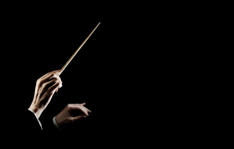 Orchestra conductor music conducting. Hands of conductor with baton