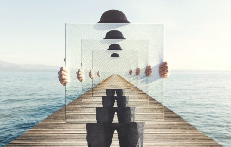 Infinitely repeating image of person holding mirror