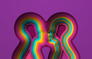 Two colorful paper cut people together on isolated background.