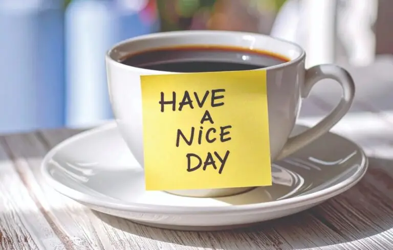 Coffee cup with sticky note that reads have a nice day