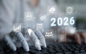 Human and robot hand typing with digital screen showing 2026