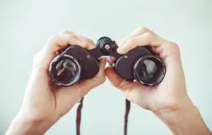man holding binoculars