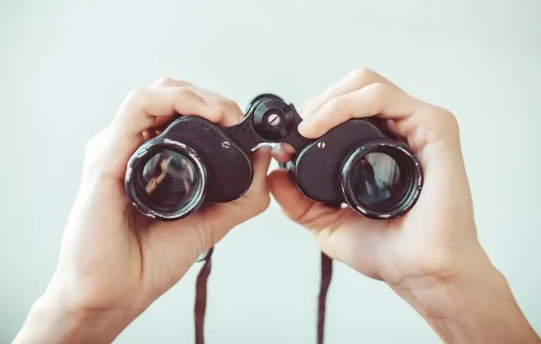 man holding binoculars