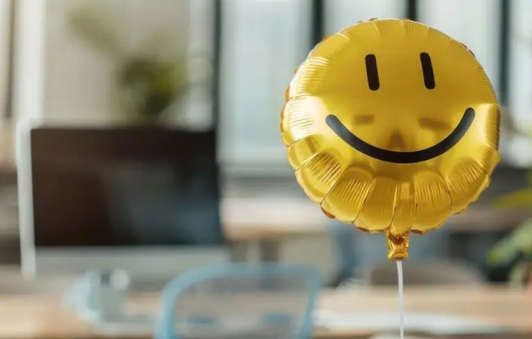 Smiley face balloon in an office