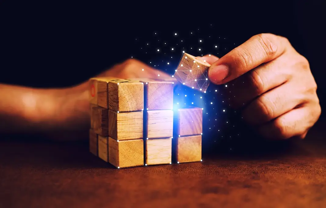 business man try to build wood block on wooden table and blur background