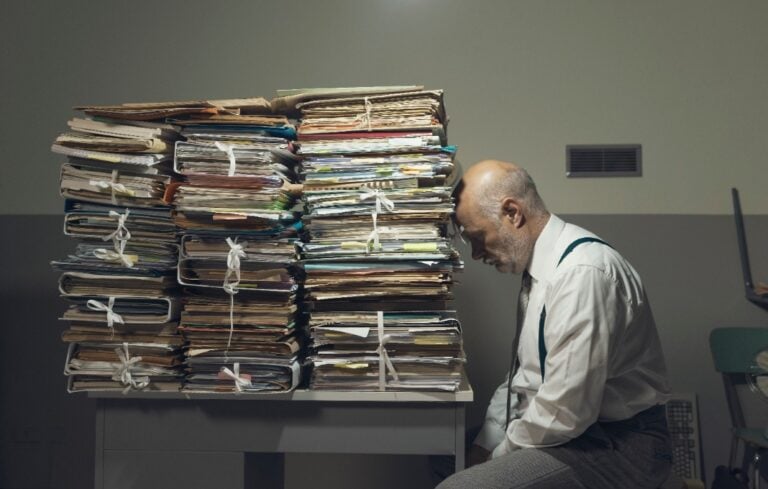 business executive with lots of paperwork