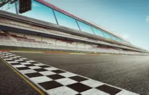 Wide angle view empty asphalt international race track with start and finish line , motion blur effect apply .