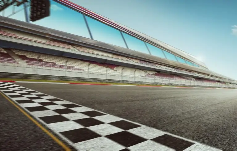 Wide angle view empty asphalt international race track with start and finish line , motion blur effect apply .