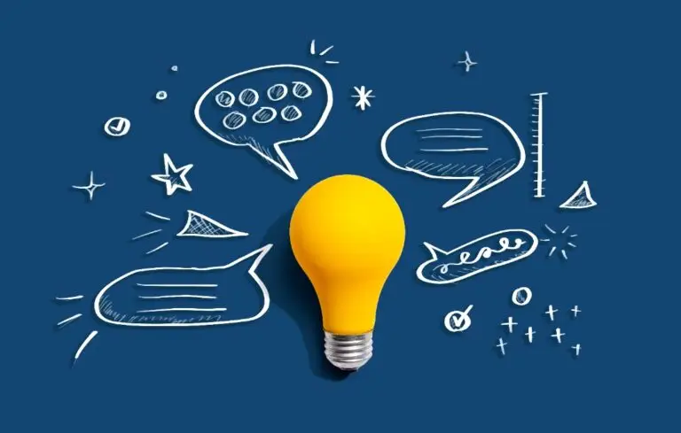Brainstorming concept with a light bulb and speech bubbles - Flat lay