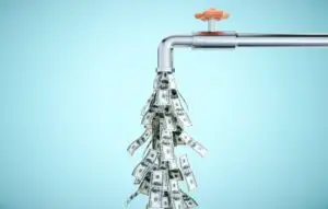 Water tap dripping dollar banknotes