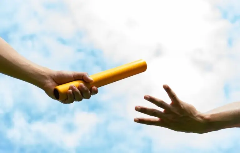 Close up hand set baton from hand to hand on sky background.