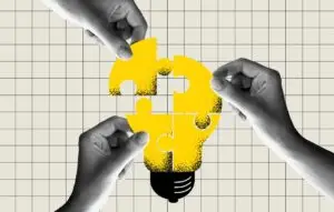 people connecting puzzle elements of a bulb