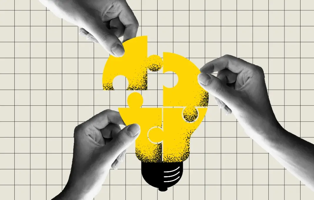 people connecting puzzle elements of a bulb