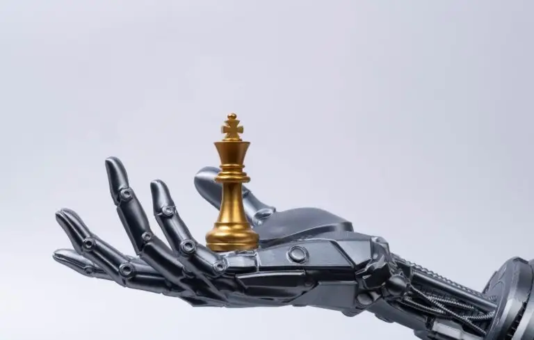 Futuristic robotic hand holding chess king piece on minimal background