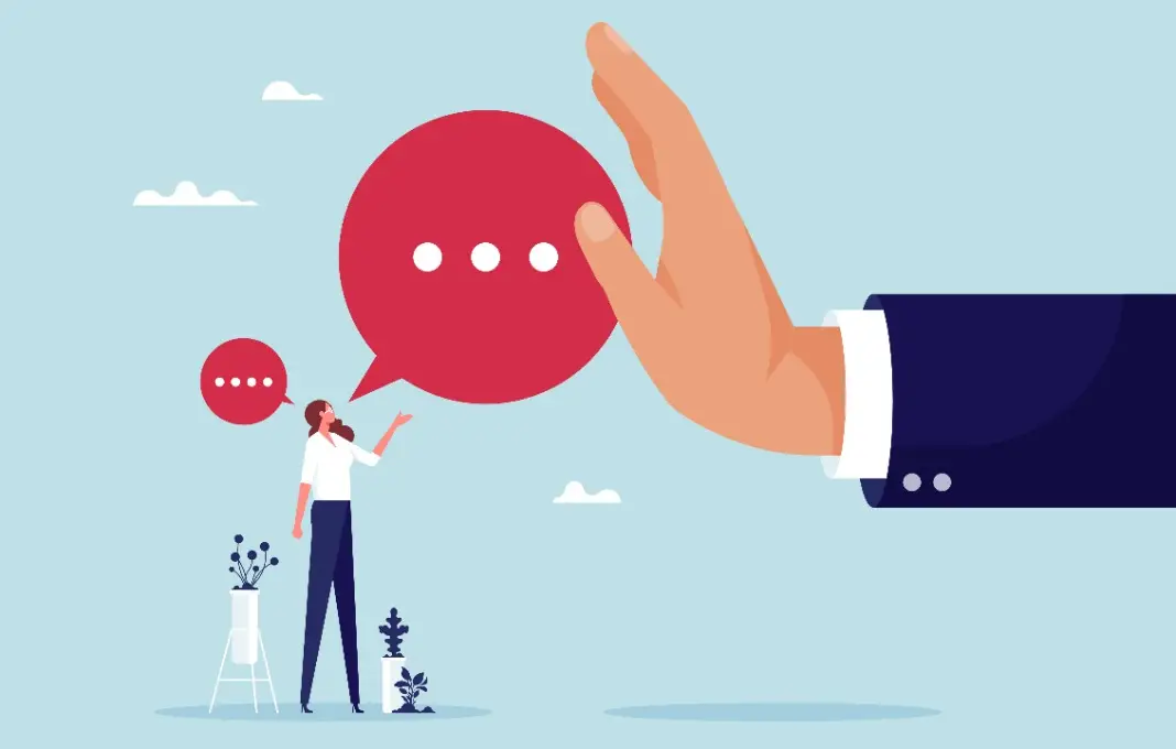 Large hand of businessman blocking speech bubble