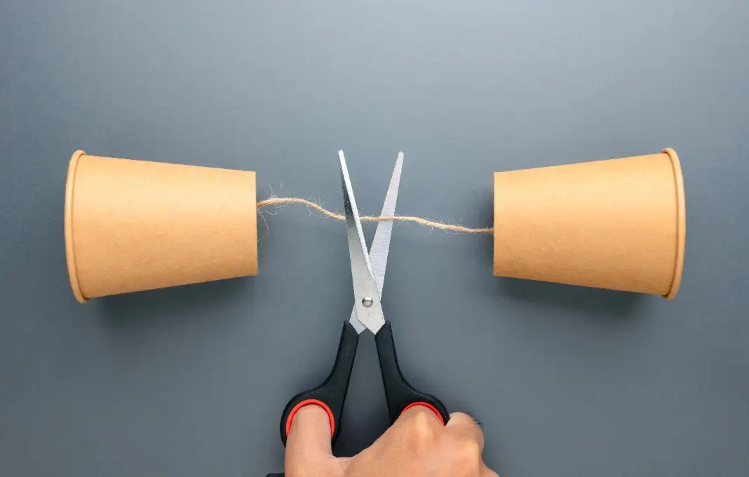 Communication breakdown and loss of connection concept with cut string phone