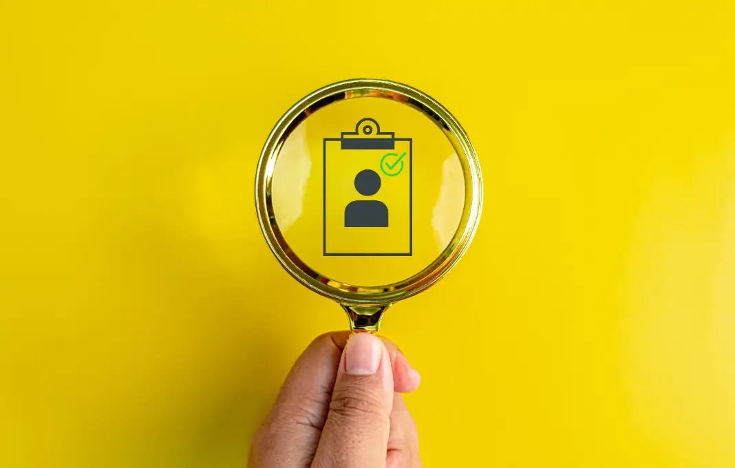 Magnifying glass over image clipboard with person outline