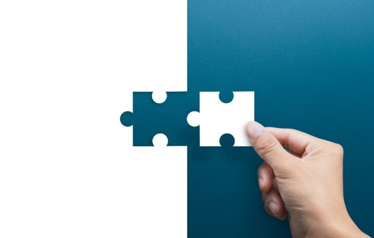 businessman hand connecting puzzle pieces