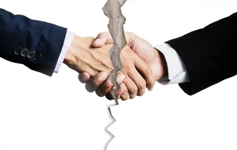 Image of shaking hands being ripped in half