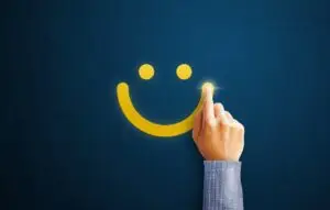 Hand drawing yellow smiley face on blue background