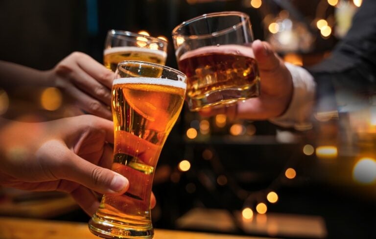 clinking glasses at a bar or pub.
