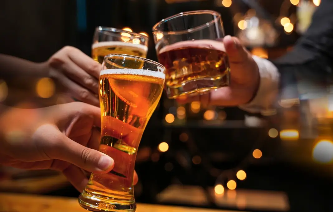 clinking glasses at a bar or pub.